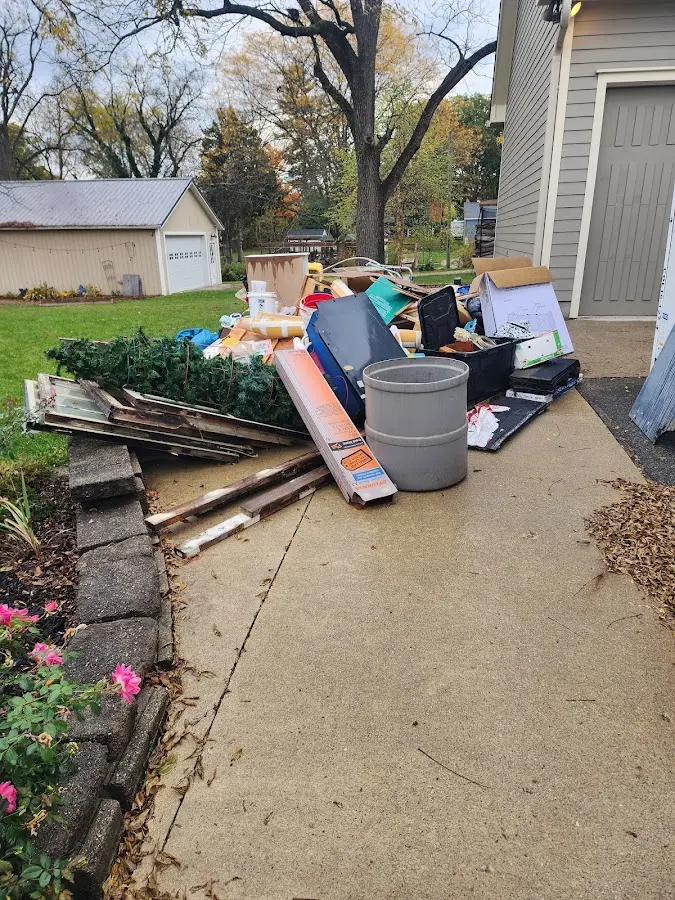 Dumpster being loaded with debris for Estate Cleanout Dumpster Rental in Mulberry